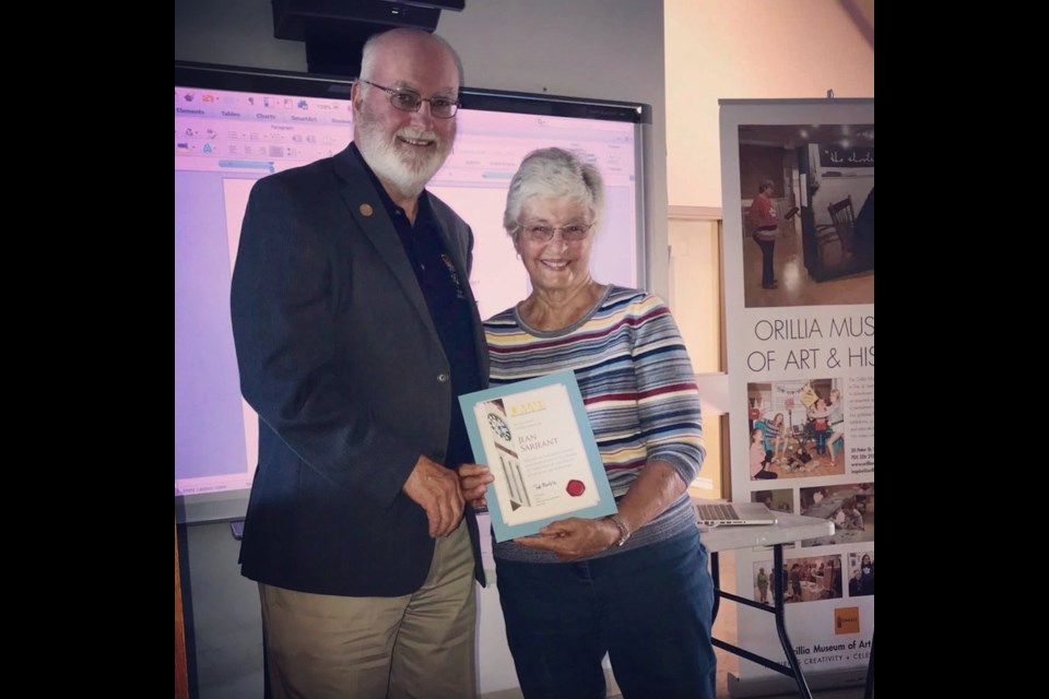 Ted Duncan, past president of the Orillia Museum of Art and History board of directors, presents Jean Sarjeant with a certificate of appreciation for her time on the board.