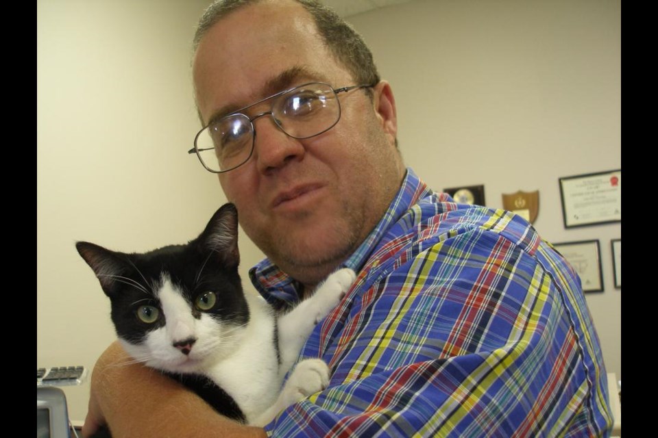Long-time local sports writer and journalist Mike Dodd passed away this weekend. Here he is shown with one of his beloved cats, Sylvester.
