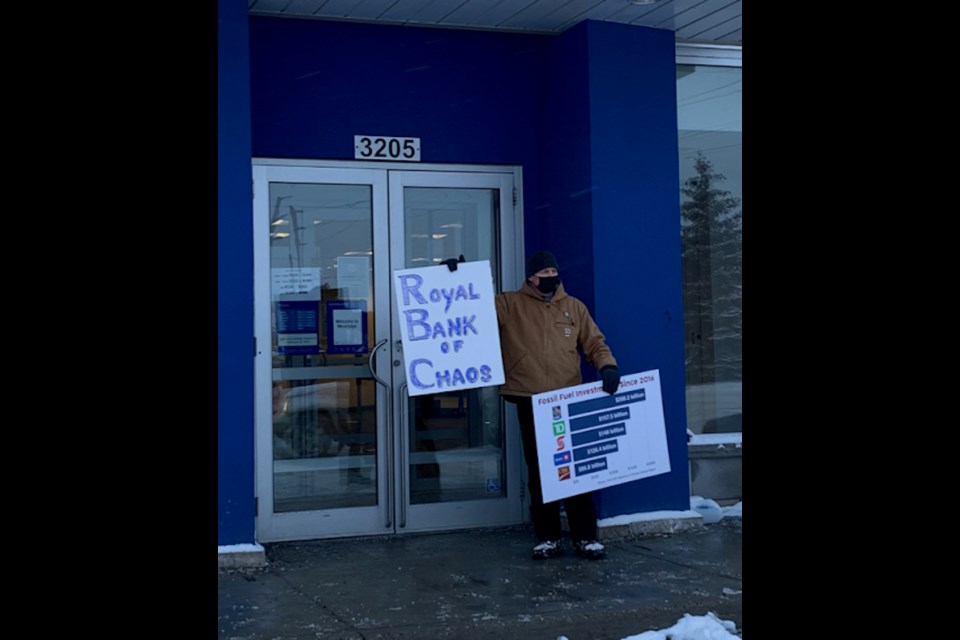 A man who goes by Xavier Bergeron, an alias used to protect his identity, was protesting RBC's involvement with the fossil fuel industry on Monday afternoon at the bank's branch in west Orillia. 