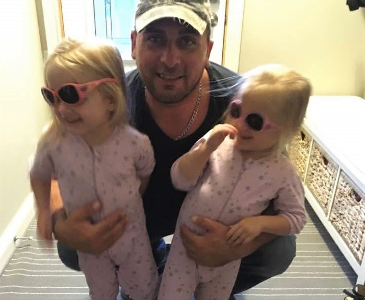 Mike Grelowski is shown in this Facebook photo with his twin daughters. He is in critical condition following Wednesday night's crash on Highway 11. Facebook photo