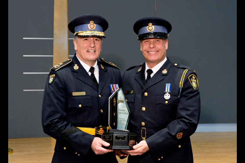 Detective Sergeant Bill Gofton, right, an Orillia native, was named  Officer of the Year and presented his award by Interim Commissioner Brad Blair.