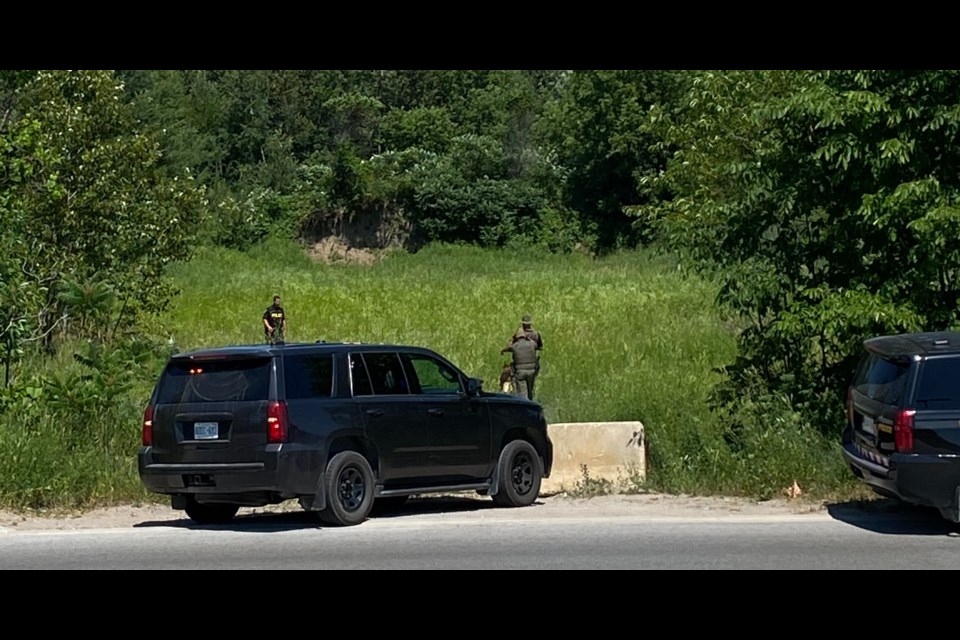 The OPP's canine unit was pressed into service to track down a suspect who fled a stolen vehicle and then fled police. He was found near Fairgrounds Road. Sam Hossack Media