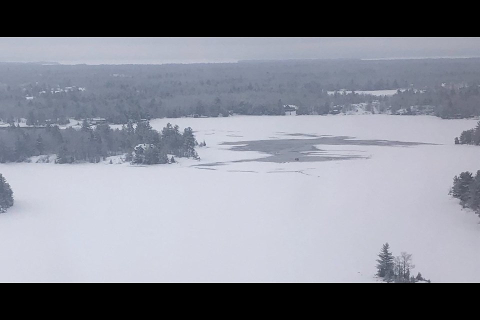 This is an aerial view of Six Mile Lake where two snowmobiles and two males plunged into the frigid waters on Sunday morning. One person was rescued. The body of the other snowmobiler was recovered this afternoon.