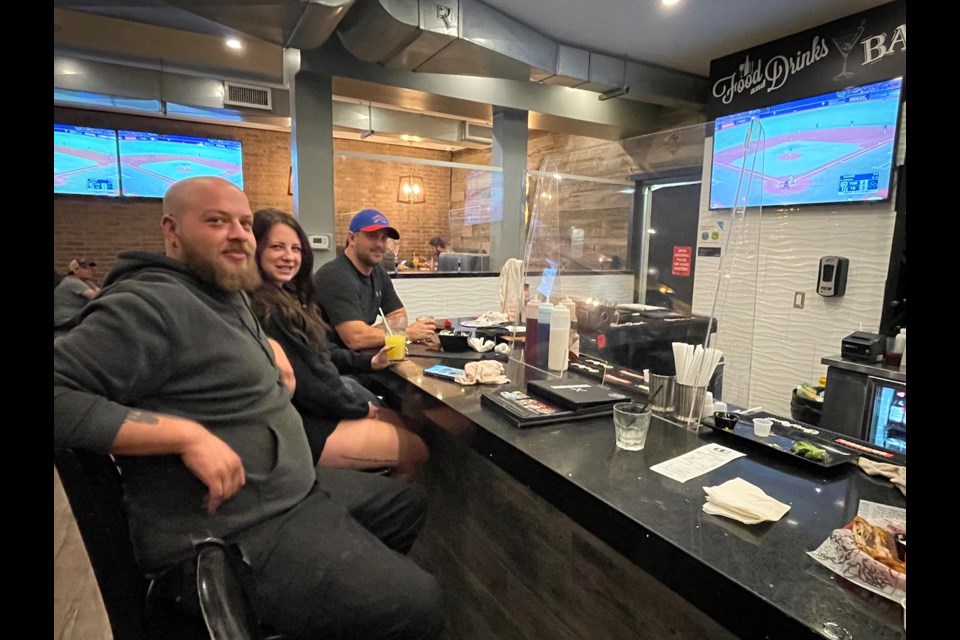 Dylan Kay, Mysty McDonald, 
and Matt Parsons were enjoying appetizers and beer during the Toronto Blue Jays game on Monday night. The federal election was in the back of their minds as they followed the Jays' game.
