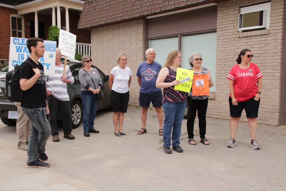 A small group gathered around the speakers at a rally held outside Simcoe-North MPP Jill Dunlop’s office Monday afternoon. The event was organized by Orillia for Democracy. Mehreen Shahid/OrilliaMatters