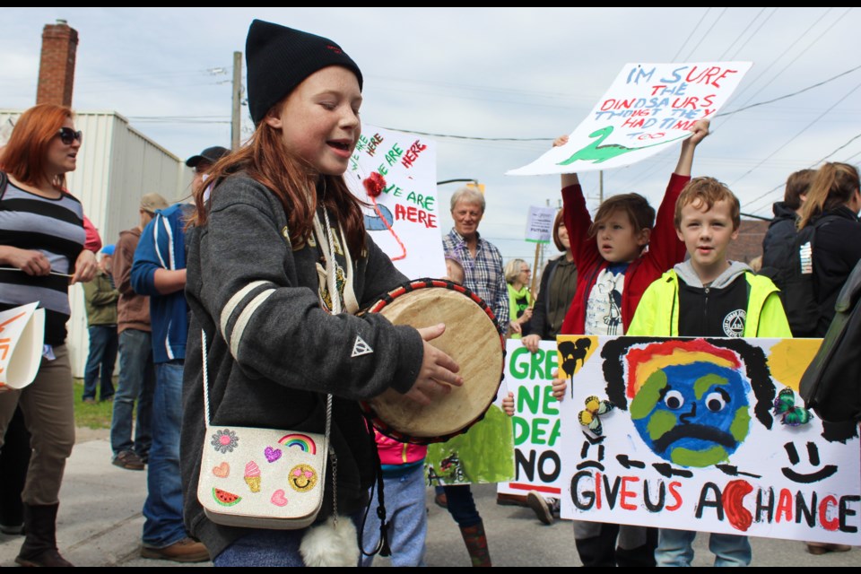 Alida Tomasini, left, beats the drum as Mason Hannaford-Fox, centre, and Seth Budd chant Friday, Sept. 27, 2019, during a climate strike march in front of the Orillia City Centre. A group of grandmothers believe they, too, have a role to play in fighting climate change. Nathan Taylor/OrilliaMatters File Photo