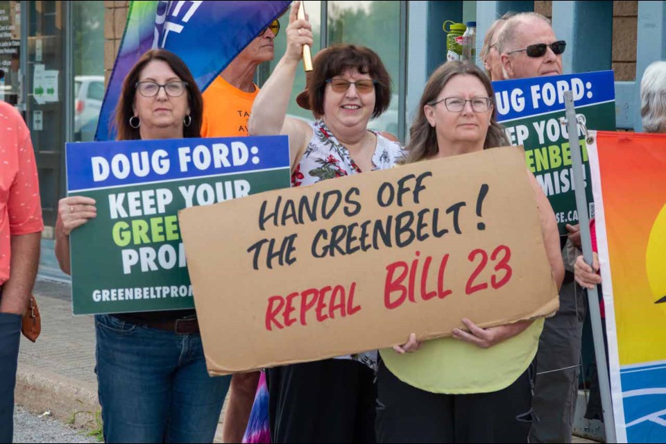 Approximately 100 people gathered in front of Simcoe North MPP Jill Dunlop's office on Monday night to protest the Ford government and the Greenbelt scandal. 