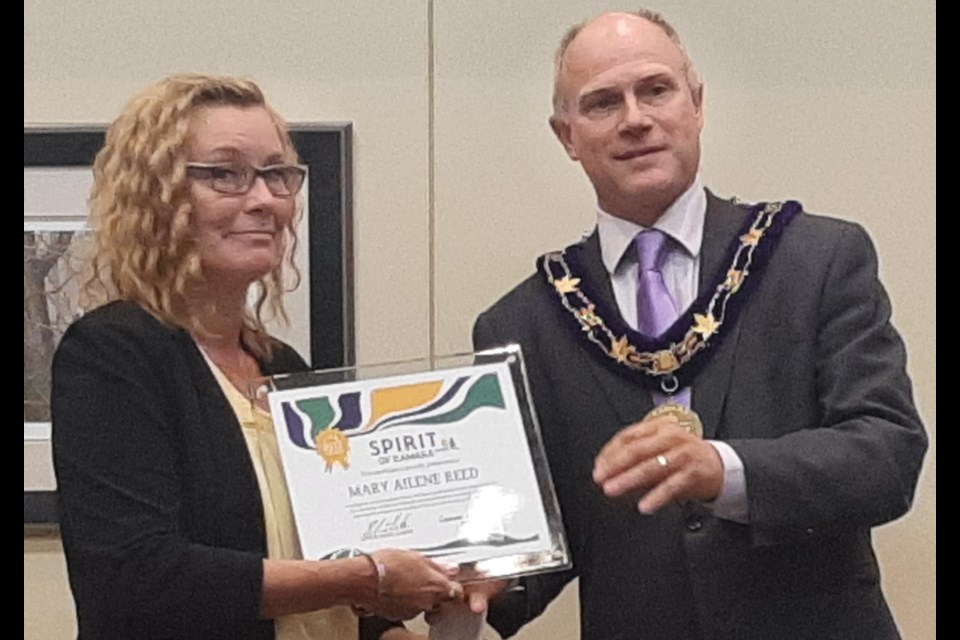 Mary Ailene Reed accepts one of two inaugural Spirit of Ramara awards from the township's mayor, Basil Clarke.