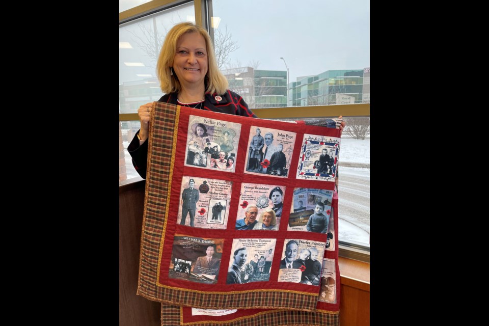 Lori Oschefski, founder of the organization Home Children Canada, displays a quilt she made, with the assistance of local quilter Joanne Clark, to commemorate British home children.