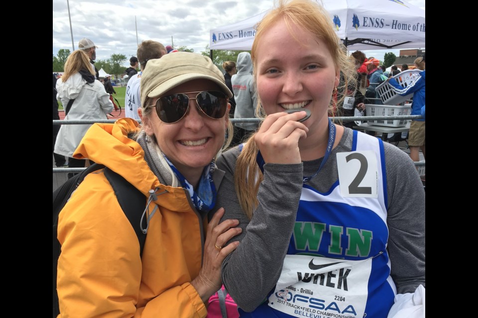 Brittney Yurek savours her silver medal win at OFSAA with former Twin Lakes track team coach Adele LeMaire.