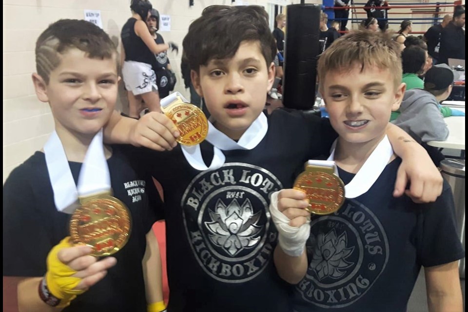 Black Lotus Kickboxing competitors Derek McMaster, Jaden Simcoe and Jacobe Black show off the medals they won at the Frosted Friends Tournament.