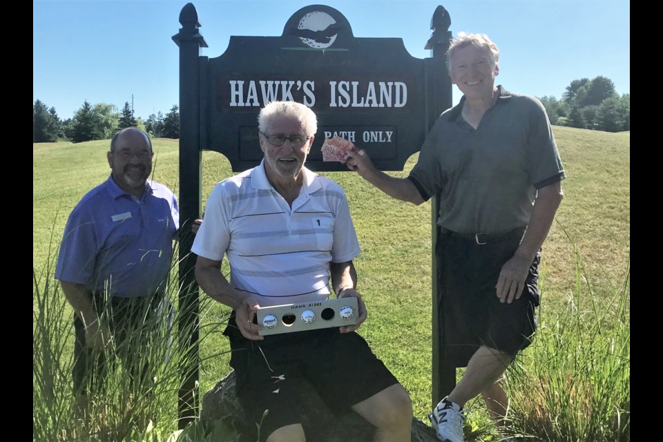 Phil Smith, a long-time member of Hawk's Island at Hawk Ridge Golf Club scored his third career ace on Tuesday June 20. Smith hit a pitching wedge to the 110-yard fourth hole for the second ace on that hole in the past four seasons. He also aced the second hole at Hawk's Island in 2012 to bring his total to three. He is pictured here with golfing partner Jack Olmstead, right, and Hawk Ridge Teaching Professional Terry Smith, left.
