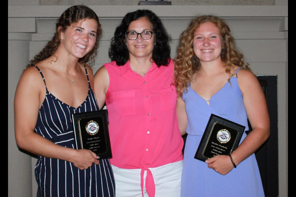 Annie Lloyd, left, and Rachel Mochulla, right, are flanked by Joanne Stanga, who presented each with the coveted award named in her honour.