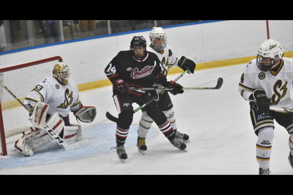 Orillia Terriers forward Owen King jockeys for position in front of Stayner goalie Marcus Semiao during first-period action Saturday night at Rotary Place. King’s screen helped Orillia blueliner Matthew Priest score a first-period power-play goal. Orillia upset Stayner 2-1 in overtime. Dave Dawson/OrilliaMatters