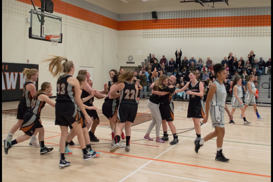 Members of the Orillia Secondary School senior girls' basketball team storm the court after the final buzzer in Tuesday's GBSSA championship victory over Joan of Arc. Tyler Evans/OrilliaMatters