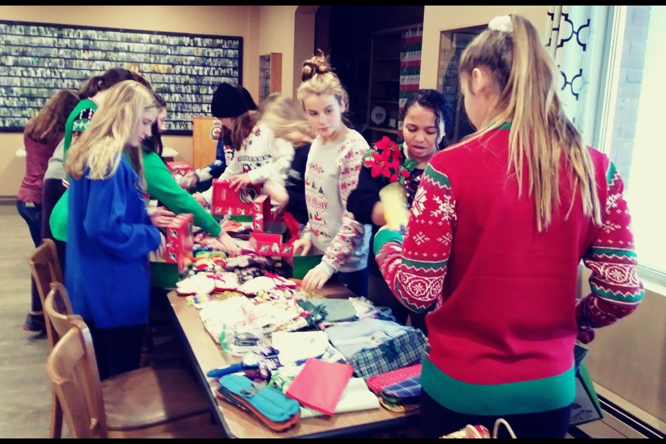 Members of the Orillia Legion Lakers major midget girls donned Christmas sweaters at the Legion and helped pack shoeboxes to be distributed in third-world countries by Operation Christmas Child.