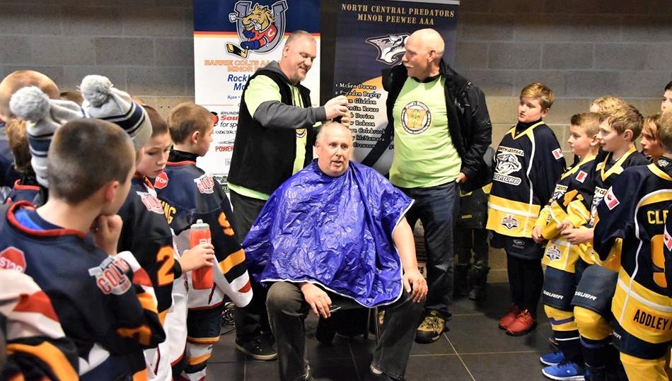 Roger Crandell, the president of the North Central Predators AAA hockey organization, gets his hair cut as part of a challenge to raise money for a Barrie hockey player fighting non-Hodgkins Lymphoma.