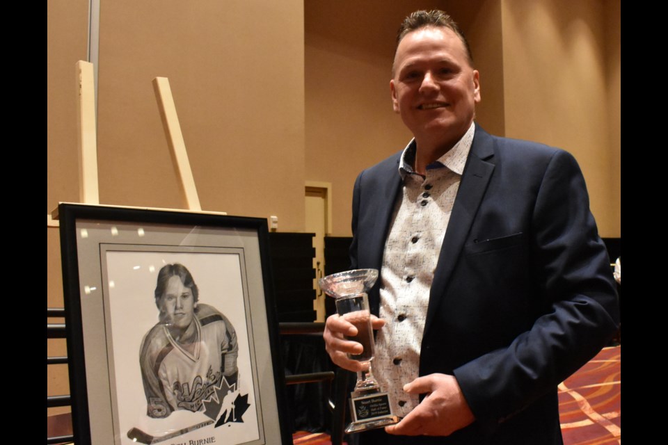 Stu Burnie poses with his crystal trophy and his portrait after being inducted into Orillia's Sports Hall of Fame Saturday night at Casino Rama. Dave Dawson/OrilliaMatters