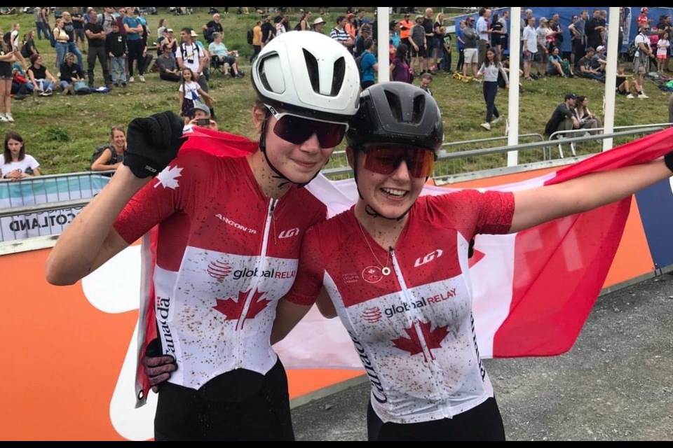 Isabella Holmgren (left) celebrates after winning the Cycling Super Worlds in Scotland with her teammate, Marin Lowe, who brought home the silver medal.