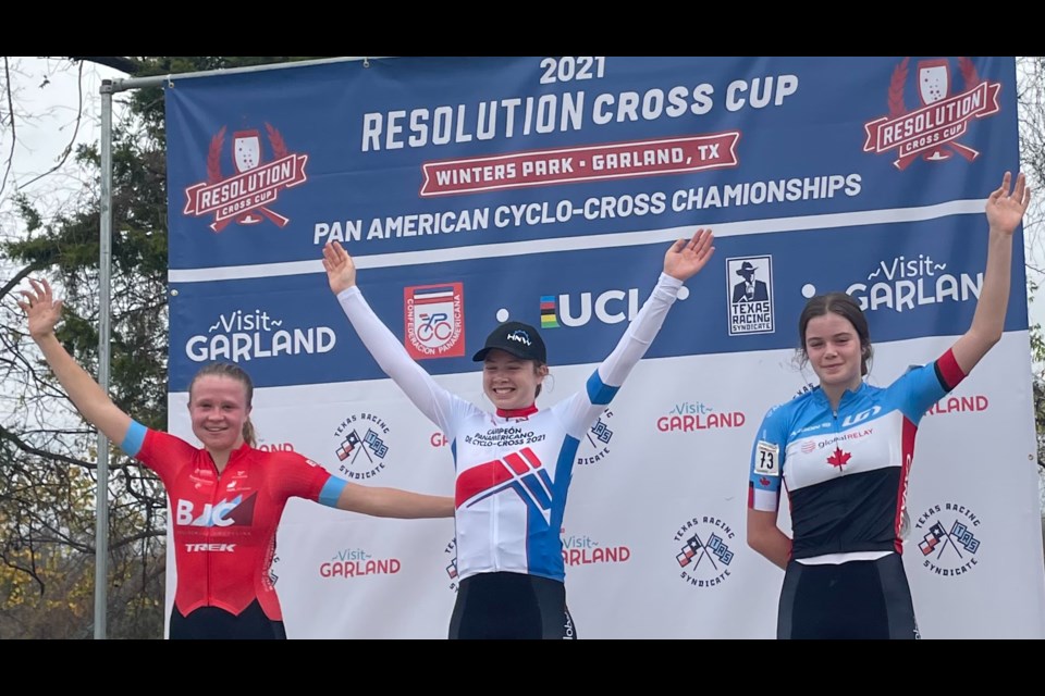 Orillia's Ava Holmgren raises her arms in victory after winning the junior women's race at the Pan American Cyclocross Championship in Texas. Her twin sister, Isabella, right, finished a strong third.