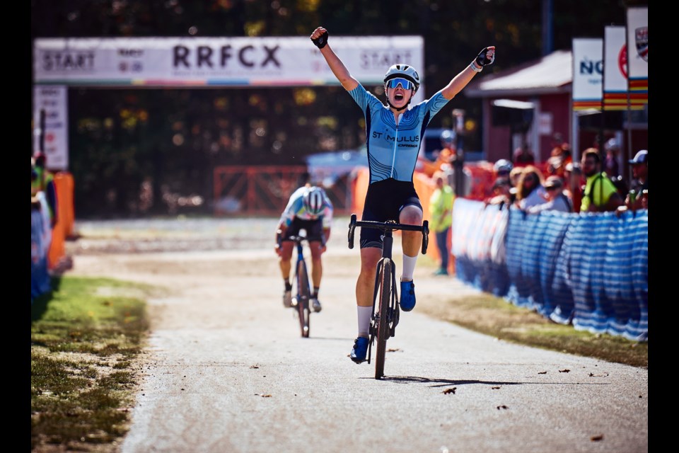 Ava Holmgren lifts her arms in victory after successfully defending her junior women's title at the Pan American Cyclocross Championship in Falmouth, MA. Photo courtesy @cxhairs