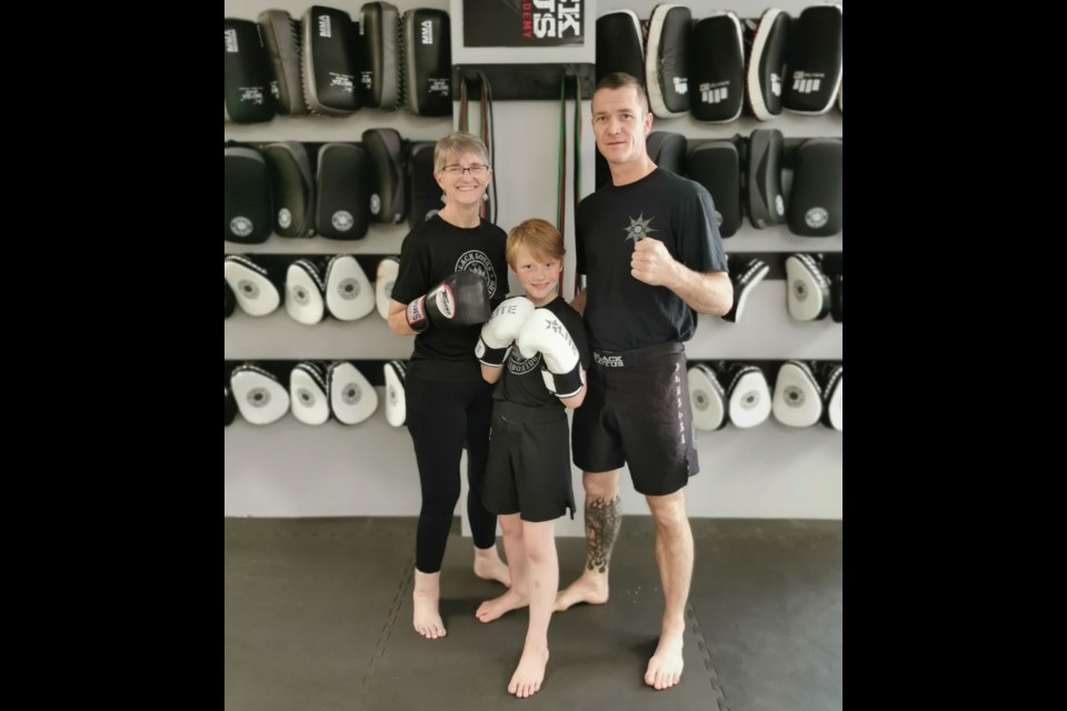 Black Lotus Academy of Martial Arts and Fitness owner, Nic Langman, stands proud with his mother Hilma and son Nikko. 