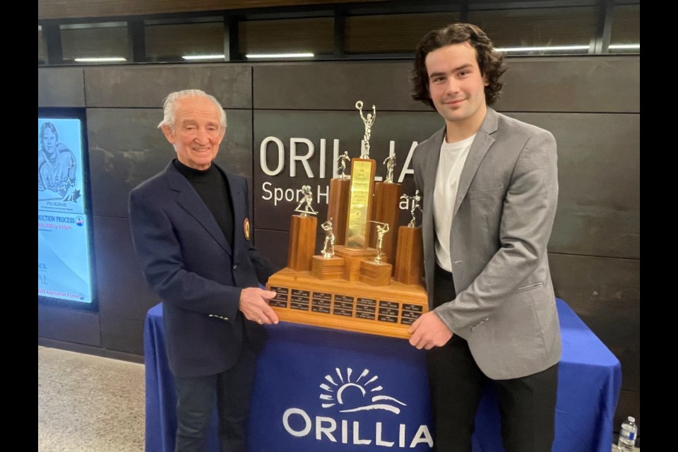Orillia Sports Hall of Fame member Walter Henry, a former Orillia athlete of the year, presents Orillia's Athlete of the Year award to Colby Barlow at a special ceremony Thursday night.