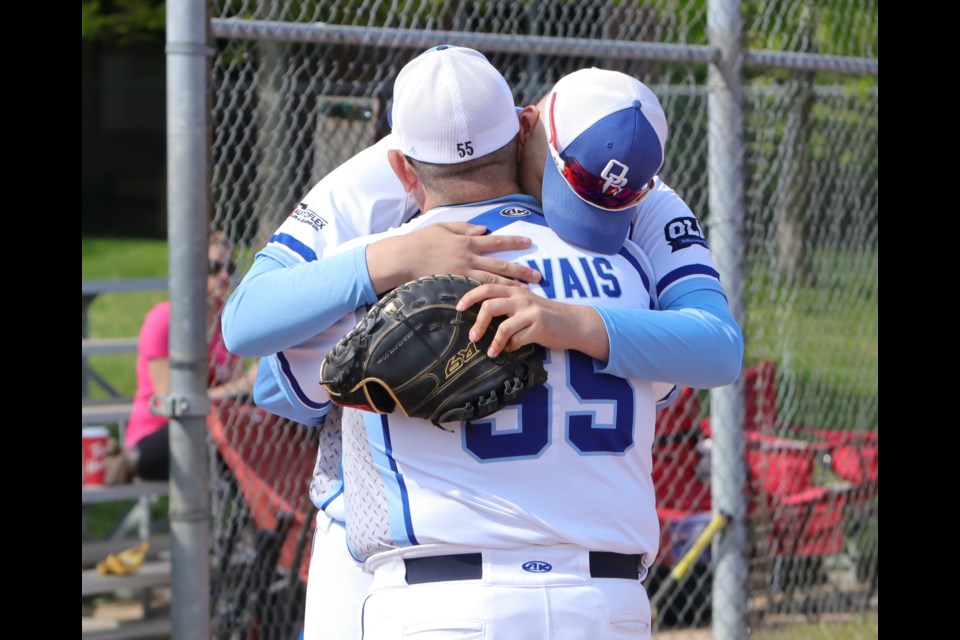 Orillia Royals pitcher Dylan Gervais shares an emotional moment with his coach and father Mike before throwing the ceremonial first pitch on opening weekend.  