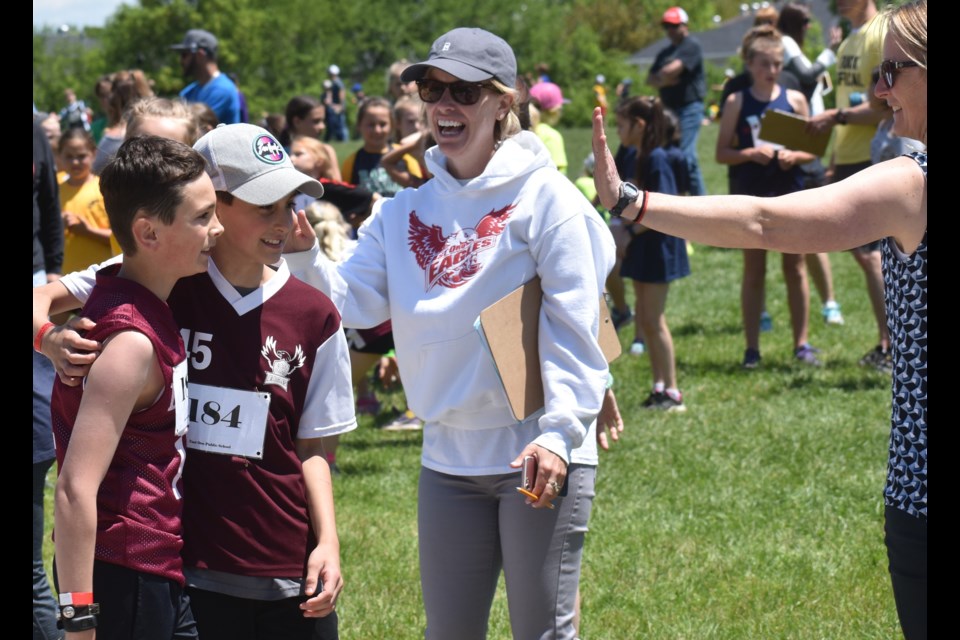 After winning his heat in the 400-metre competition, this runner from East Oro Public School is congratulated for his efforts. The race was one of dozens at Tuesday's Area Track and Field Championship for students in Grades 4-6 at Twin Lakes Secondary School. Dave Dawson/OrilliaMatters