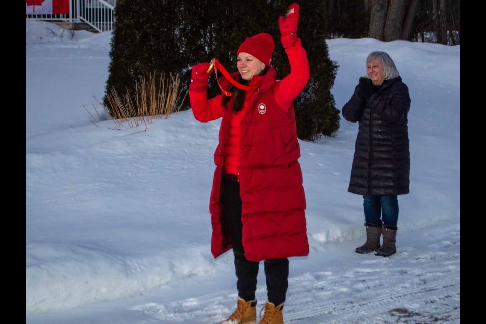 Olympic hockey gold medallist, Erin Ambrose, waves to her Joyland Beach neighbours who congratulated her with a walk-by parade on Wednesday night. 