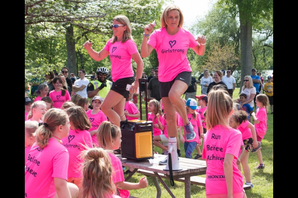 Girlstrong founders Dianne Barr and Pattie Freeman lead 700 local students in a dance warm-up prior to the start of a three-kilometre run at Tudhope Park that capped the six-week Girlstrong program. Tyler Evans/OrilliaMatters
