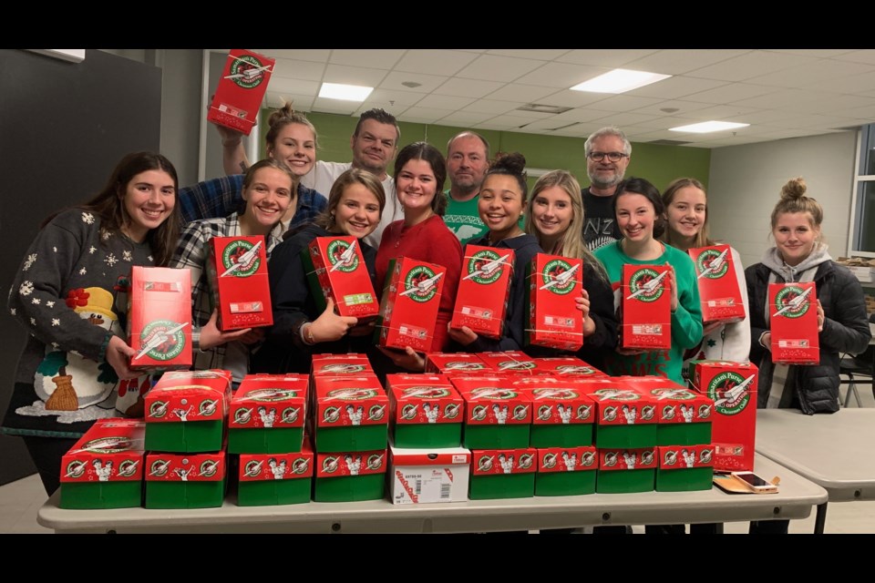 Members of the Orillia Junior Women's Lakers proudly pose with the 40 shoeboxes they packed for Operation Christmas Child, which provides supplies and gifts to children who might otherwise not experience Christmas. Contributed photo