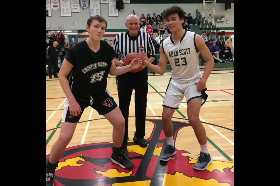 Mike McParland participates in the tip-off in this junior boys' contest to help kick off the 75th Orillia Blackball Classic Friday.
