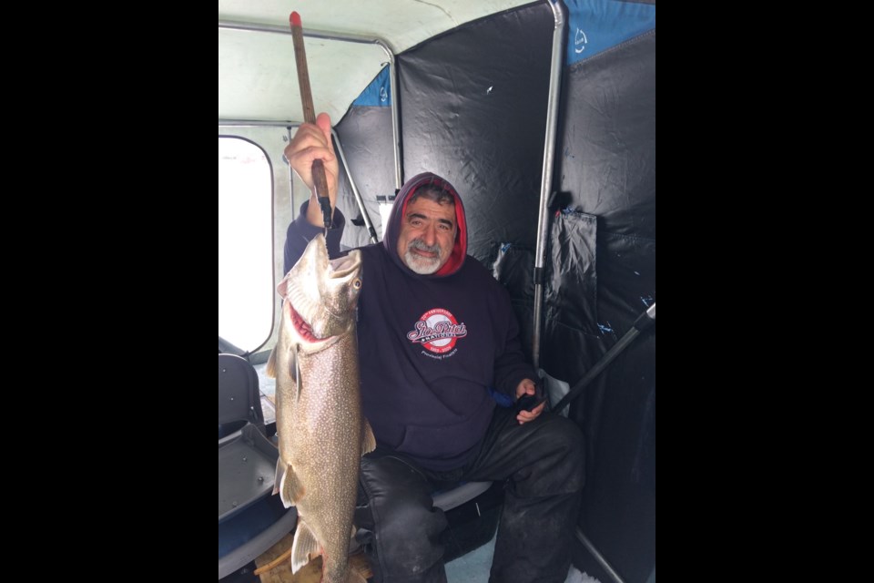 Mike Borrelli poses with a lake trout he caught on Lake Simcoe last year. 
