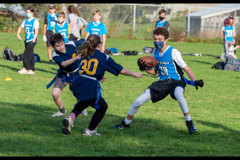 Noah Buckindale juked two Coldwater defenders on a long run during Severn Shores' 34-26 victory in elementary school flag football action on Wednesday afternoon. 
