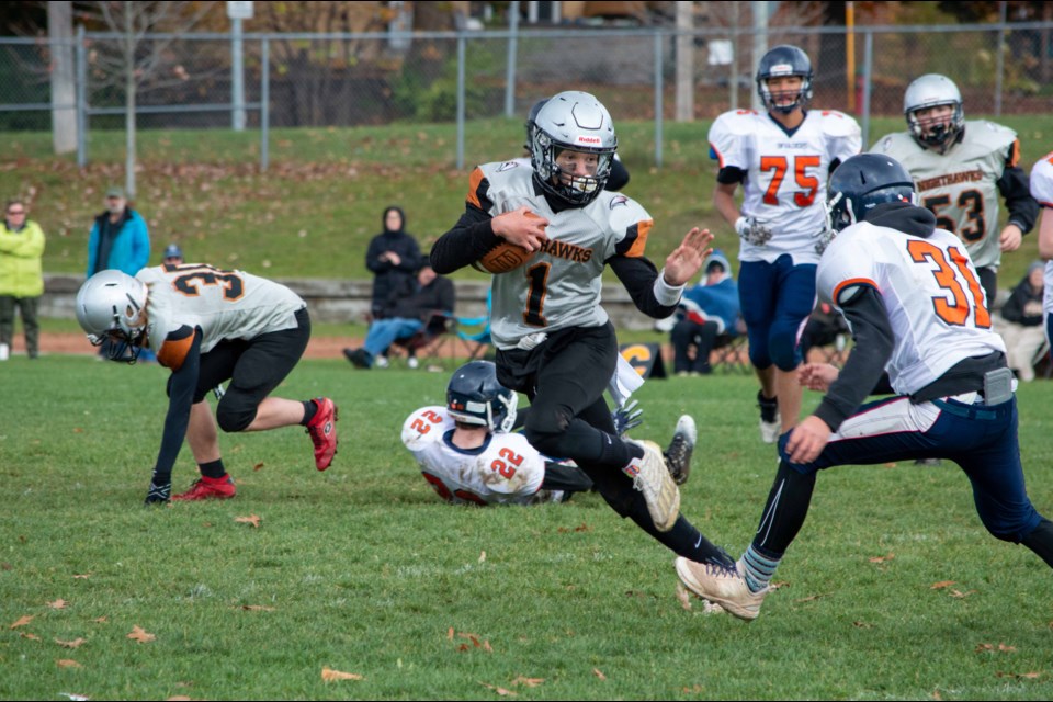 Orillia Secondary School quarterback Noah Buckindale has led the Nighthawks to the Simcoe County Athletic Association semifinals. He is shown eluding a tackle during his team's recent 44-0 victory over Innisdale Secondary School of Barrie.