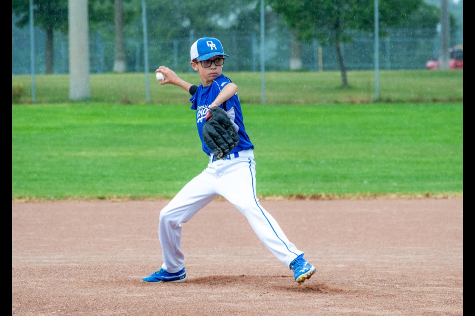Orillia Royals pitcher Holden Beers battles through the rain on Friday afternoon to deliver a strike during the 2022 Summer Classic baseball tournament. 