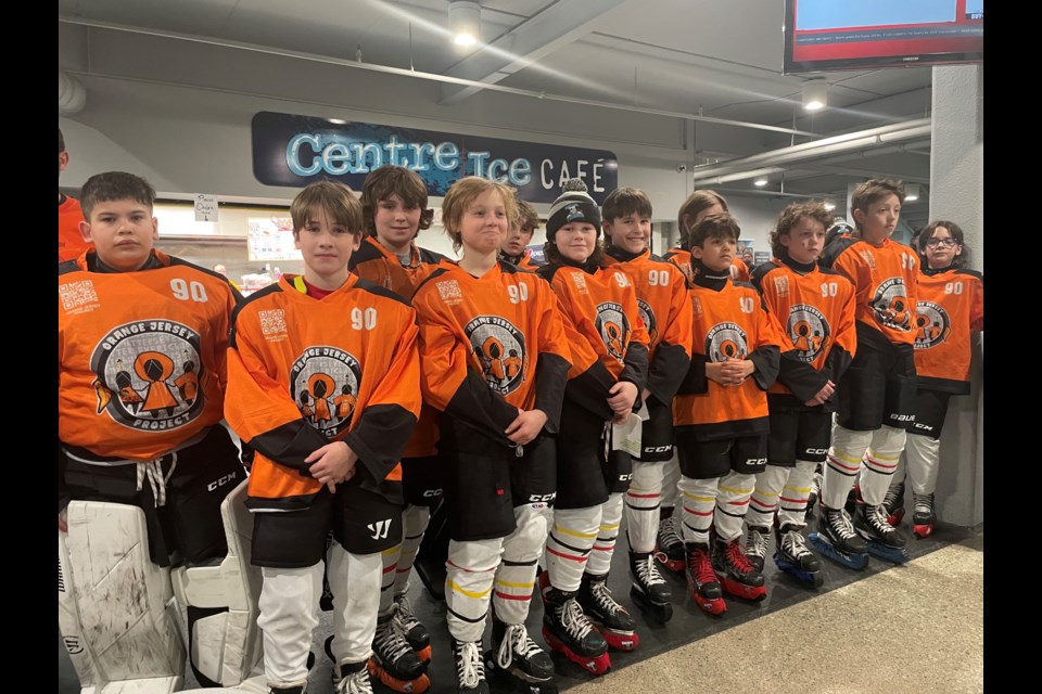 The U12 AA Orillia Terriers wore orange jerseys while watching the Orillia Secondary School Soaring Hawk Singers before their game on Wednesday evening in the main lobby of the Orillia Rotary Place. 