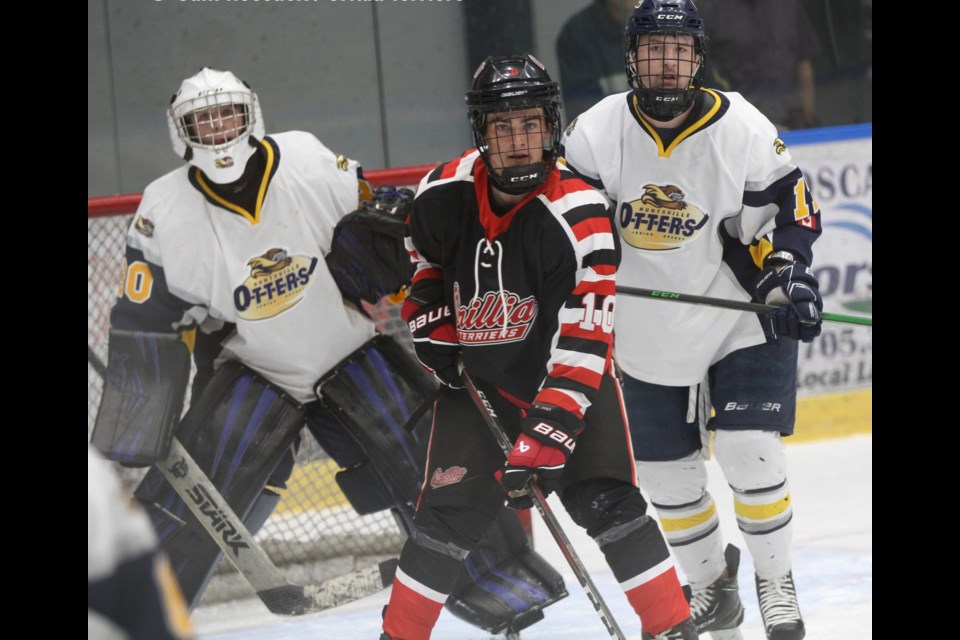 The Orillia Terriers earned a 5-2 victory over Huntsville in their Provincial Jr. C League home opener Saturday night at Rotary Place. Above, Terrier forward Noah Mountain jockeys for position in front of the Huntsville net.