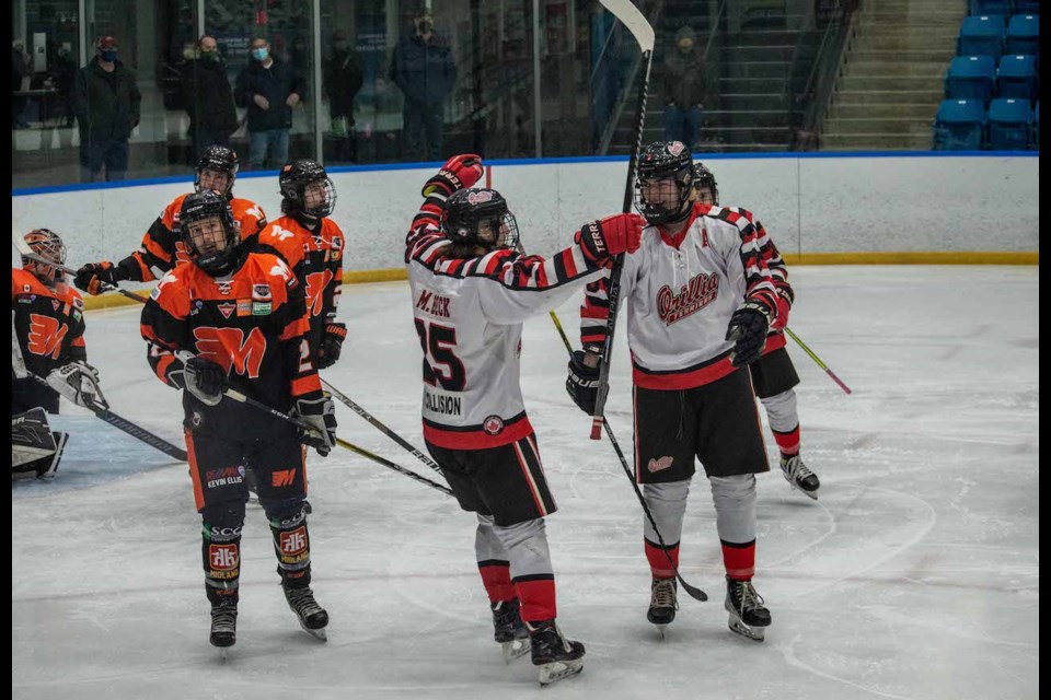 Forwards Mason Beck and Sam Pink celebrate the first goal of the game during Tuesday night's series- clinching win over Midland at Rotary Place.