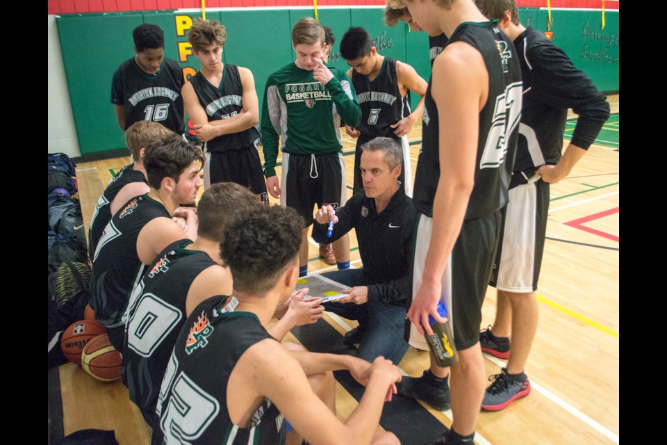 Patrick Fogarty senior boys' basketball coach Brad MacNeil motivates his team during a time out at the 75th annual Black Ball Tournament. MacNeil is popular with his players for his coaching style that emphasizes appreciating the game. Tyler Evans/OrilliaMatters