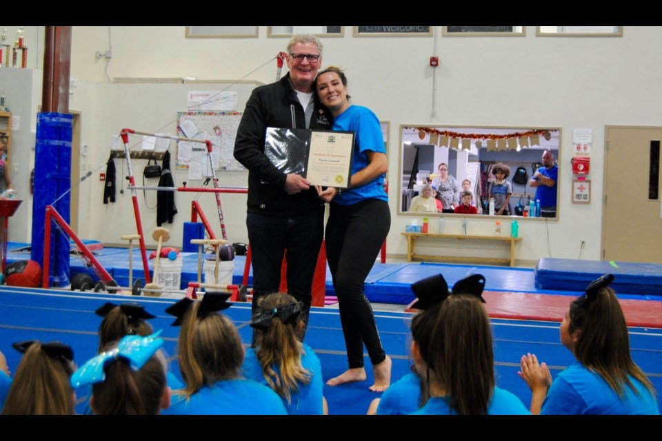 Orillia Mayor Steve Clarke presents Coach Teanna Larmand with a certificate recognizing her efforts for starting and building the Snowleopards Cheerleading Team. Micheline Theriault Ayers photo