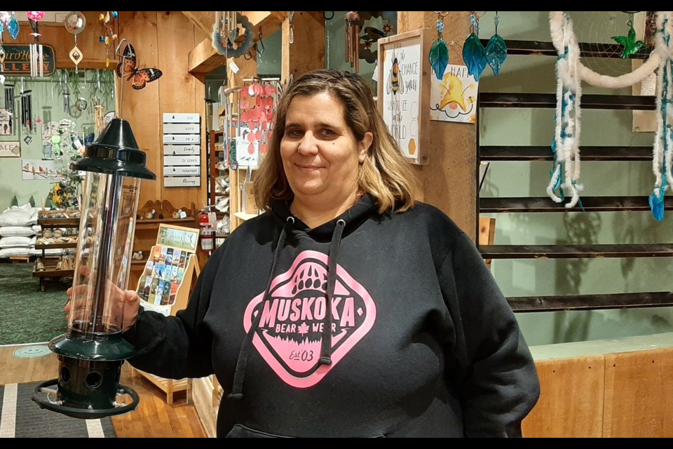 Patricia Cousineau, owner of Bird House Nature Company, displays one of the Squirrel Buster Plus feeders that were recently donated to Mariposa House Hospice and local seniors' residences.