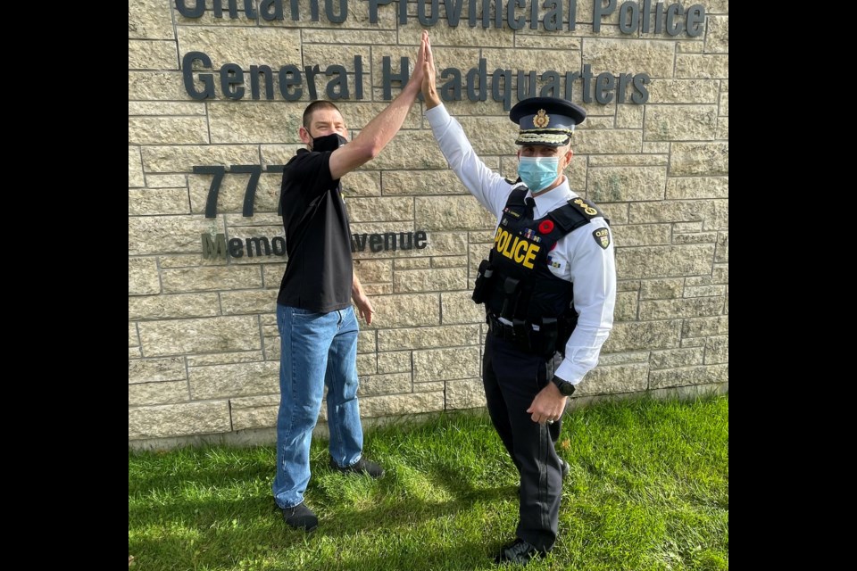 OPP Commissioner Thomas Carrique and Orillia Special Olympics athlete and ambassador Stephen Graham celebrate another successful Torch Run Guardians event. 