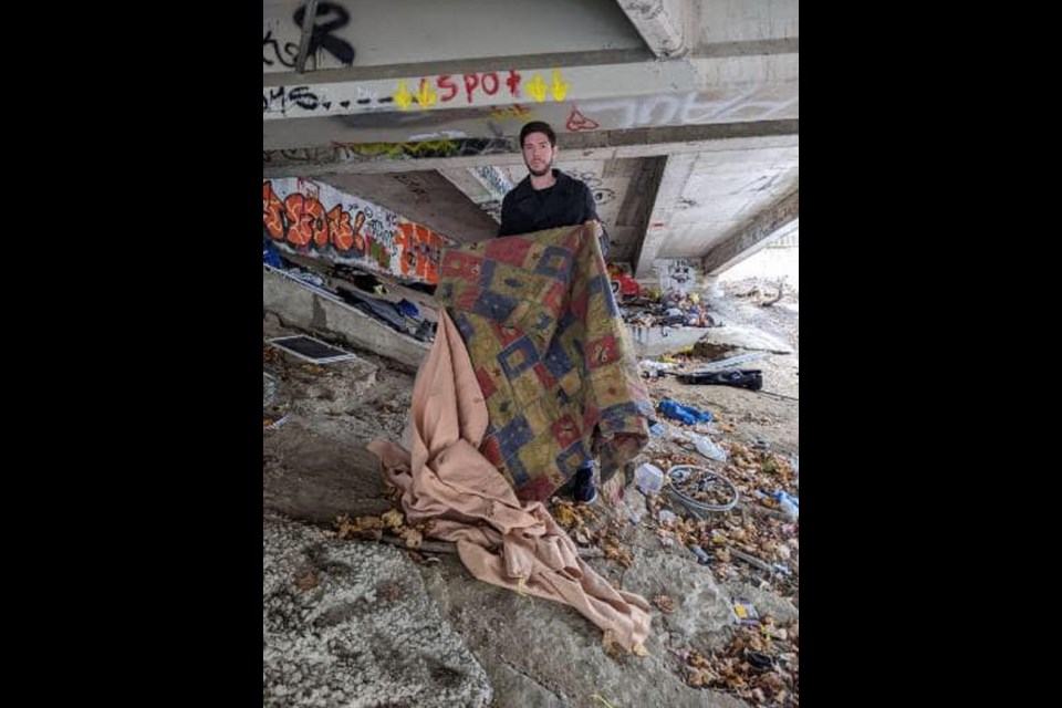 A volunteer with the Out of the Cold Program in Pembroke shows the living conditions of some of the city's homeless under a bridge near the City Hall
