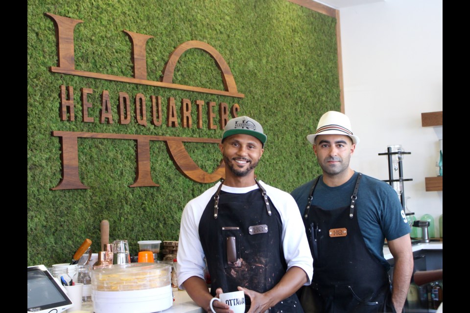 Damien Carvery (left) and Aydin Kharaghani (right) started HeadQuarters in late 2017. Kharaghani said the green wall behind the bar is made of moss. Drew May/ OttawaMatters.com