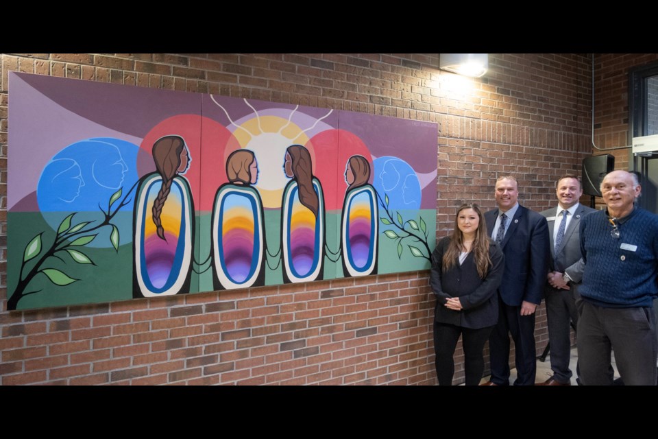 Georgian College unveiled new Indigenous artwork at the Owen Sound campus to coincide with the launch of a new Indigenization strategy. The artwork was created by Anishnaabe artist and visual storyteller Emily Kewageshig. Pictured, from left, are Kewageshig, Kevin Weaver, Georgian College president and CEO, Dave Shorey, executive director at Georgian College’s Owen Sound campus, and Greg McGregor, manager of Indigenous services at Georgian College.