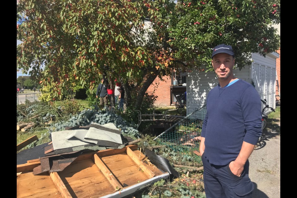 2018-09-23 Kevin Lloyd standing in front of the damage left behind from the tornado in Gatineau