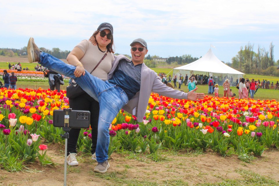 Roberto Boy and Janet Valdez ham it up at the TASC Tulip Farm on Saturday. The pair are visiting Canada from The Philippines and decided to visit the farm and share the experience on their travel blog.