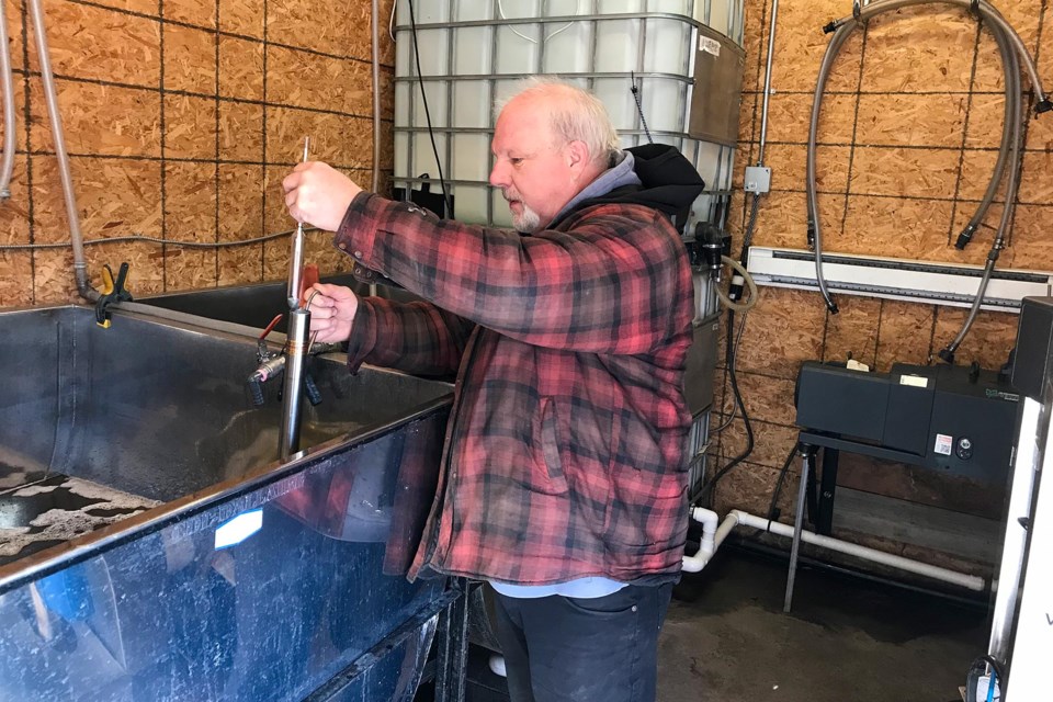 Tim Hartwick checks the sugar content of maple sap as it goes through the first step of processing—reverse osmosis.